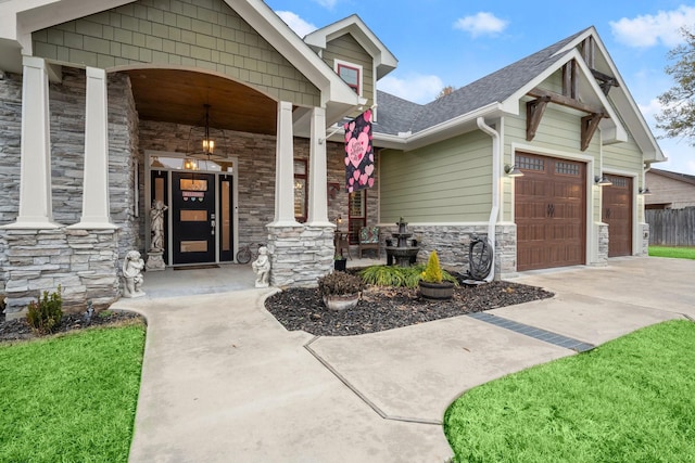 view of exterior entry featuring a porch and a garage