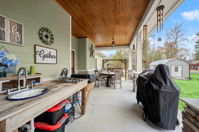 view of patio / terrace with grilling area and a storage unit