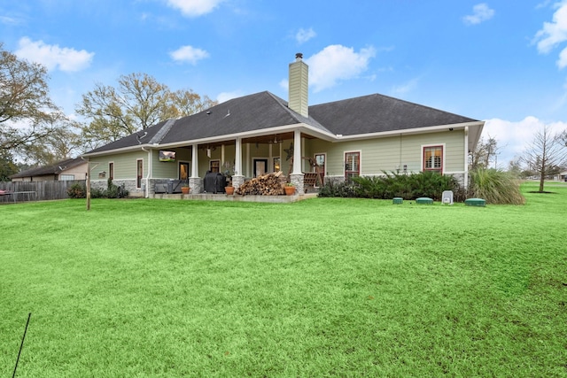 back of house featuring a yard and a porch