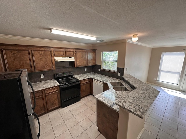 kitchen featuring stainless steel fridge, black range with electric stovetop, sink, and light tile patterned floors