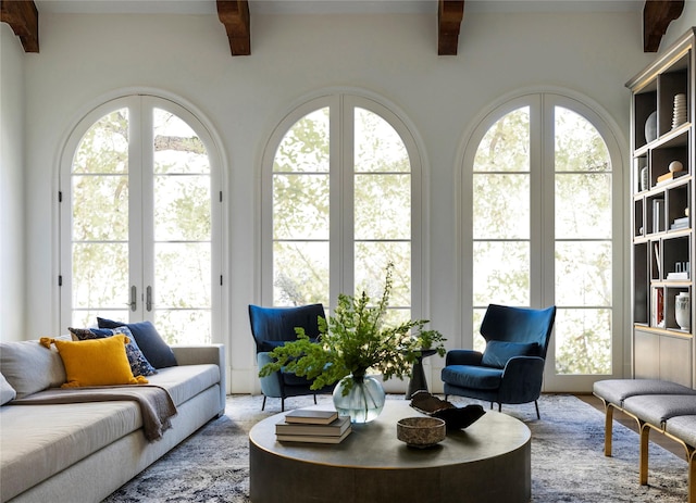 living room with beam ceiling and a wealth of natural light