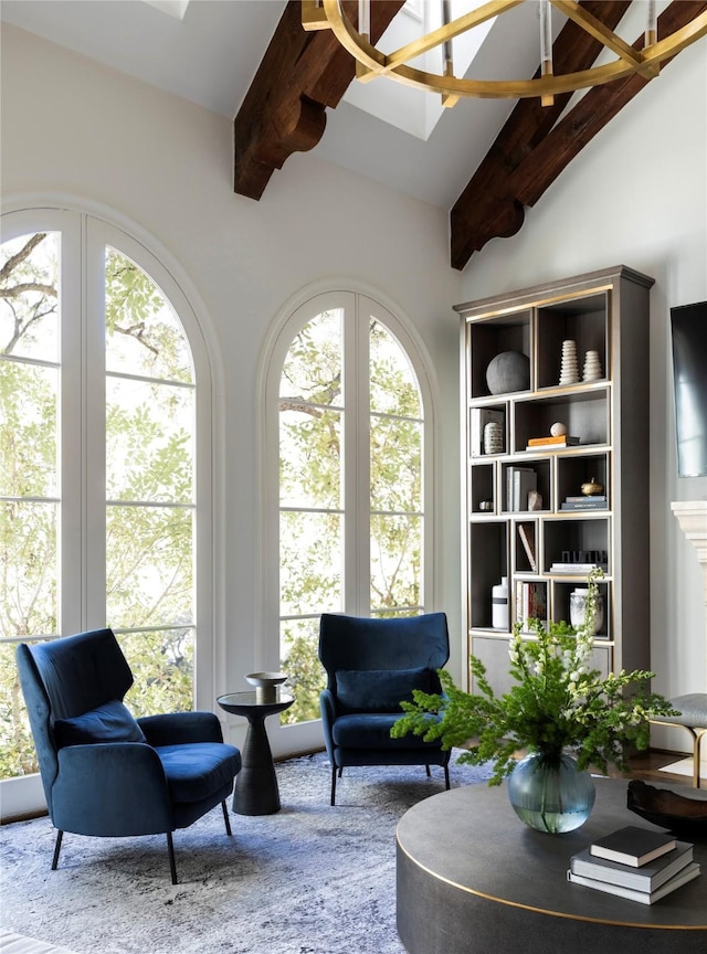 living area featuring high vaulted ceiling, a wealth of natural light, and beam ceiling