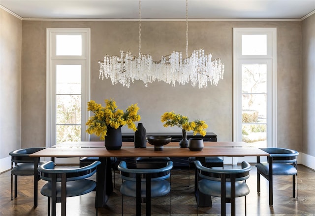 dining space featuring a wealth of natural light, parquet flooring, and ornamental molding