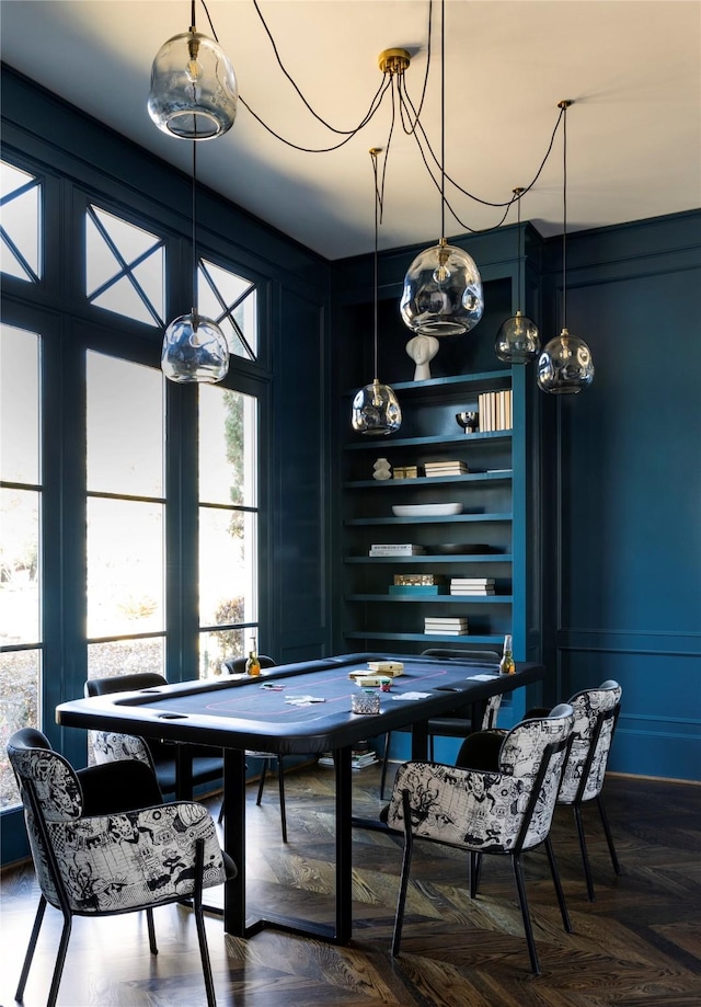 dining room with parquet floors and built in shelves