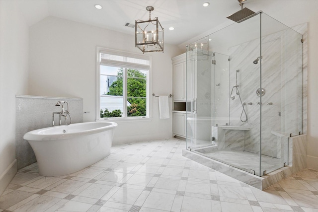 bathroom with a notable chandelier and shower with separate bathtub