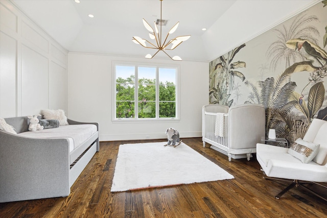 sitting room with dark hardwood / wood-style floors, a chandelier, and vaulted ceiling