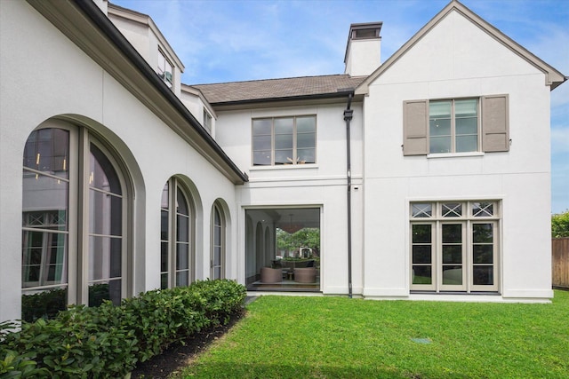 rear view of house featuring a yard