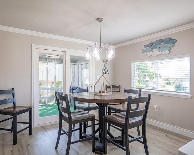 dining space featuring crown molding and light wood-type flooring