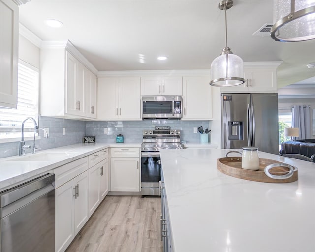 kitchen featuring sink, stainless steel appliances, and white cabinets