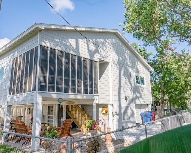 back of property with a sunroom