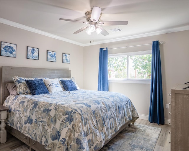 bedroom featuring crown molding, ceiling fan, and light wood-type flooring