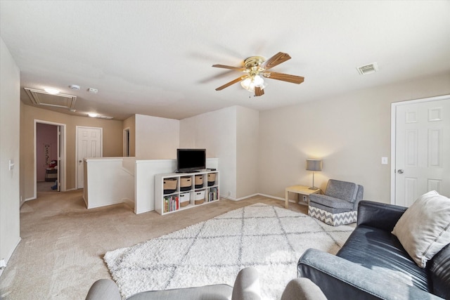 carpeted living room with ceiling fan