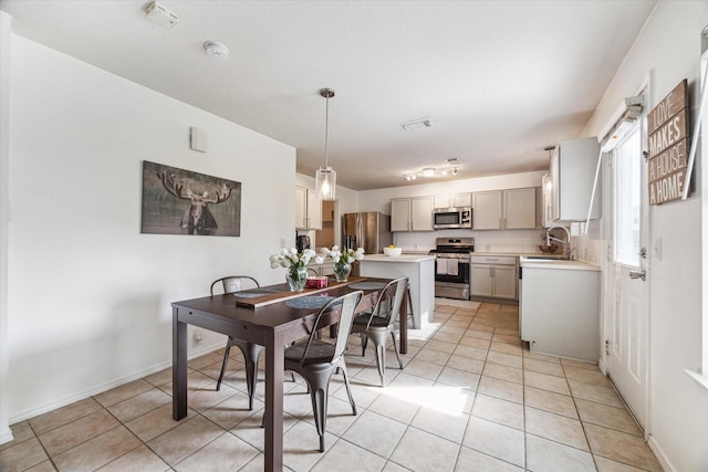 tiled dining space featuring sink