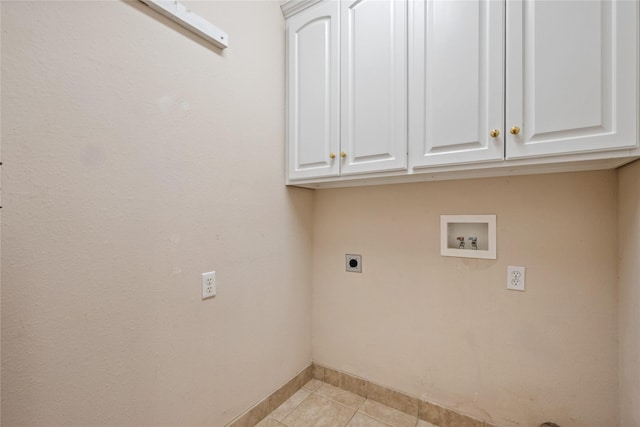 clothes washing area with light tile patterned floors, hookup for a washing machine, cabinet space, hookup for an electric dryer, and baseboards