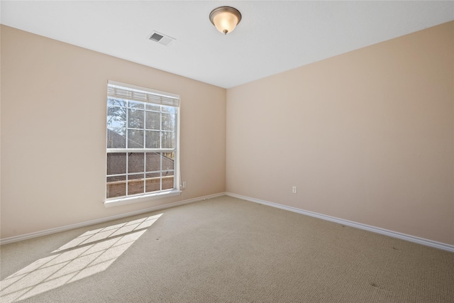 unfurnished room featuring baseboards, visible vents, and carpet flooring