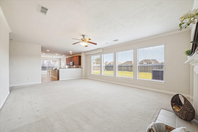 unfurnished living room with light carpet, ornamental molding, and ceiling fan