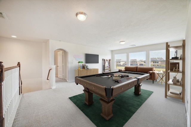 rec room featuring light colored carpet, billiards, and a textured ceiling