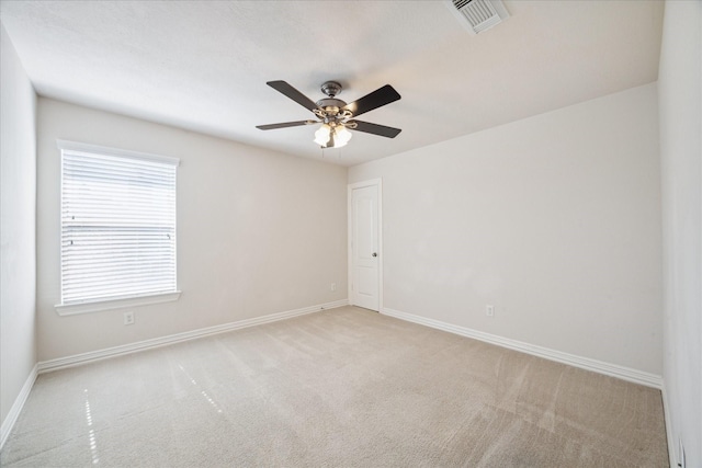 empty room featuring light colored carpet and ceiling fan