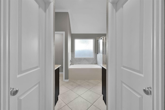 bathroom with vanity, a washtub, and tile patterned floors