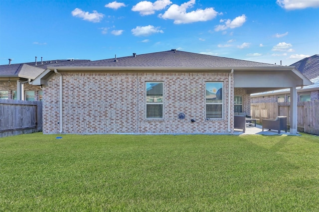 rear view of house with a lawn and a patio area