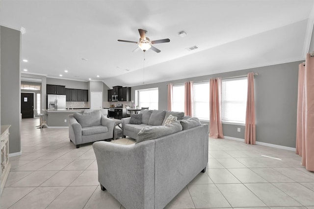 living room featuring ornamental molding, light tile patterned floors, and ceiling fan