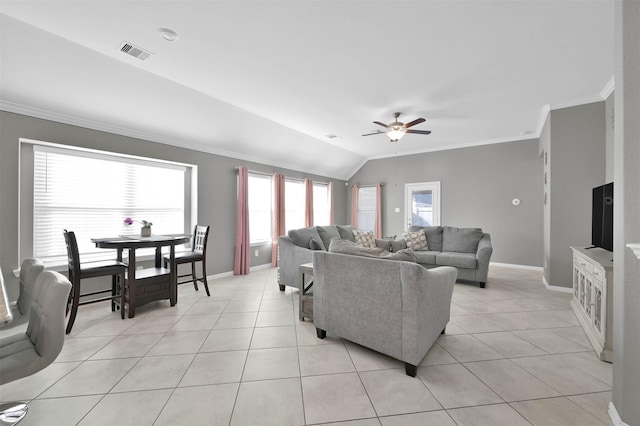 living room with ornamental molding, lofted ceiling, light tile patterned floors, and ceiling fan