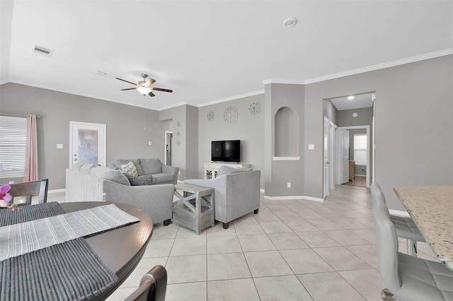 living room with light tile patterned flooring, a wealth of natural light, ceiling fan, and crown molding