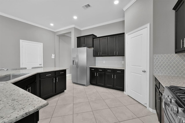 kitchen with sink, crown molding, light stone countertops, and appliances with stainless steel finishes