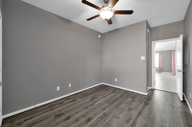 spare room featuring dark hardwood / wood-style floors and ceiling fan