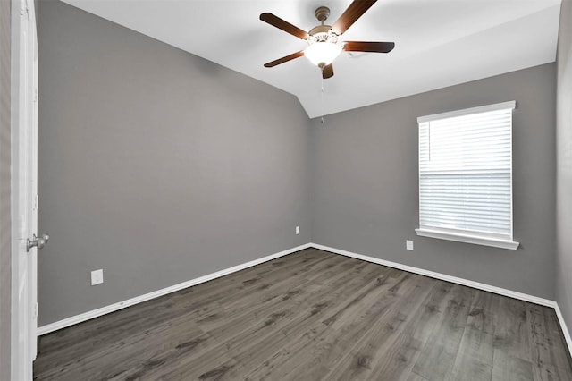 spare room featuring lofted ceiling, dark wood-type flooring, and ceiling fan