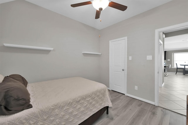 bedroom with ceiling fan and light hardwood / wood-style floors