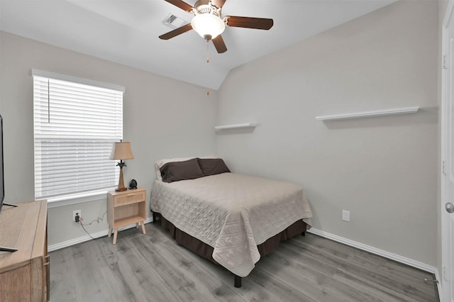 bedroom featuring hardwood / wood-style flooring, vaulted ceiling, and ceiling fan