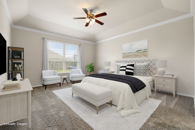 carpeted bedroom with ornamental molding, ceiling fan, and a tray ceiling