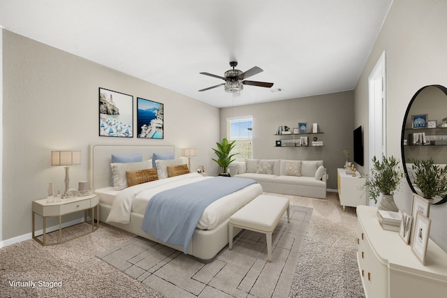 bedroom featuring light carpet and ceiling fan