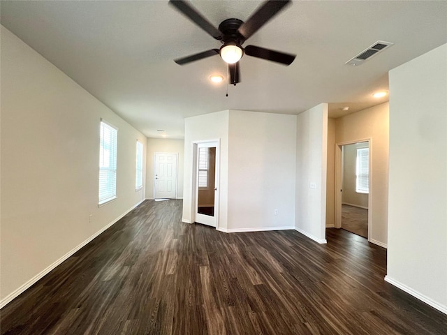 unfurnished room with ceiling fan and dark hardwood / wood-style flooring