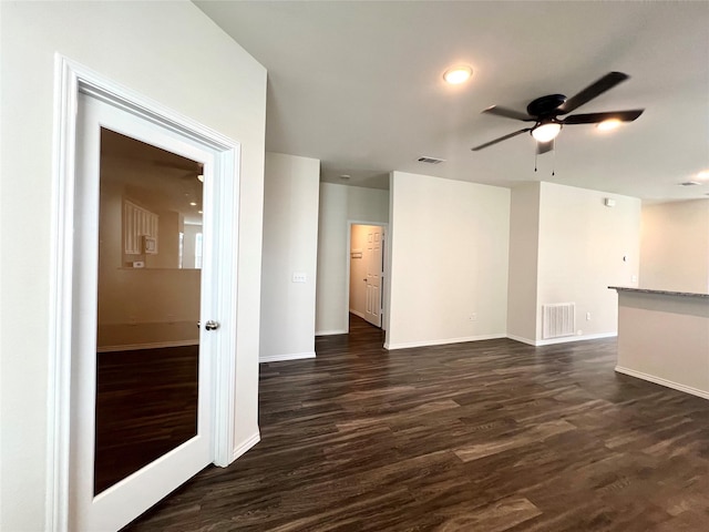 empty room with dark wood-type flooring and ceiling fan