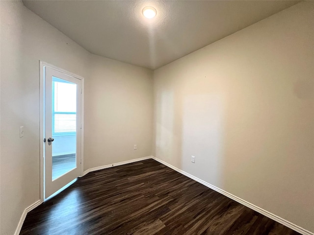 empty room with dark hardwood / wood-style floors