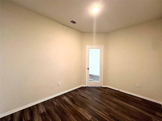 empty room with dark hardwood / wood-style floors