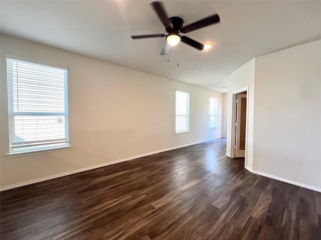 spare room with dark wood-type flooring and ceiling fan