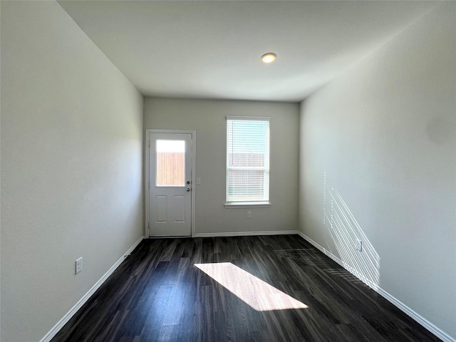 empty room featuring dark hardwood / wood-style flooring