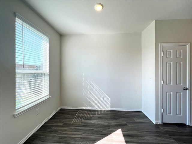 empty room with dark wood-type flooring