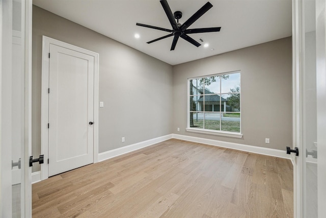 empty room with ceiling fan and light wood-type flooring