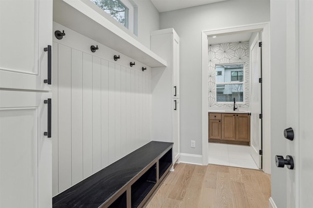 mudroom with sink and light wood-type flooring