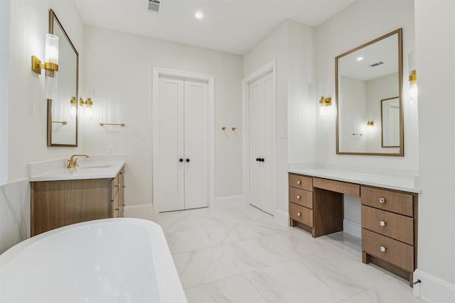 bathroom with vanity and a tub