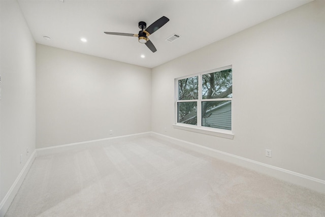 spare room with light carpet and ceiling fan