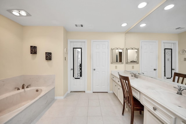 bathroom with tile patterned floors, vanity, and a bathing tub