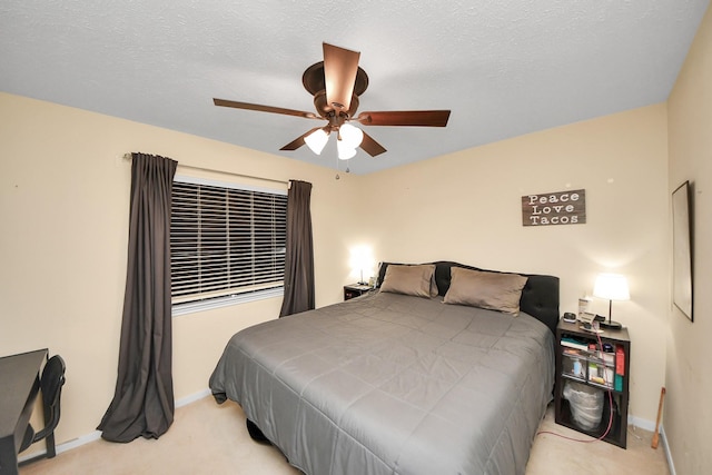 carpeted bedroom featuring ceiling fan and a textured ceiling