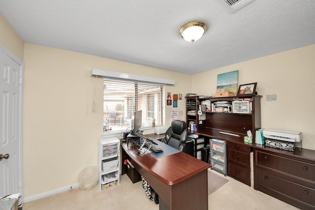 office featuring light carpet and a textured ceiling