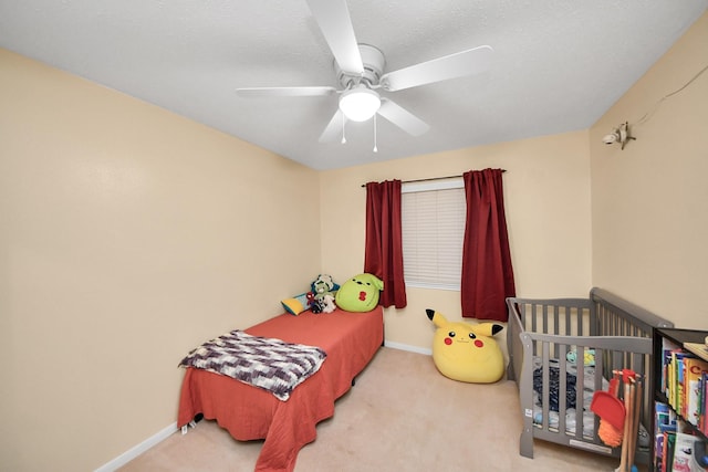 carpeted bedroom with a textured ceiling and ceiling fan