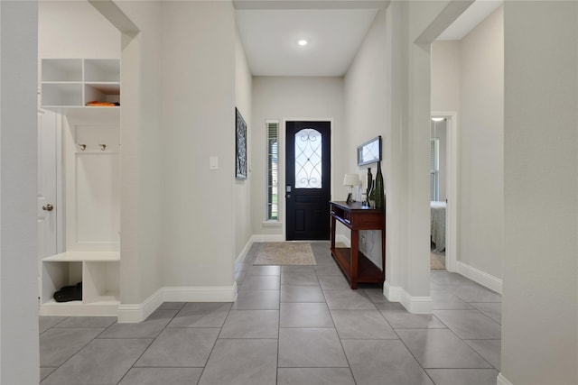 tiled entryway featuring baseboards